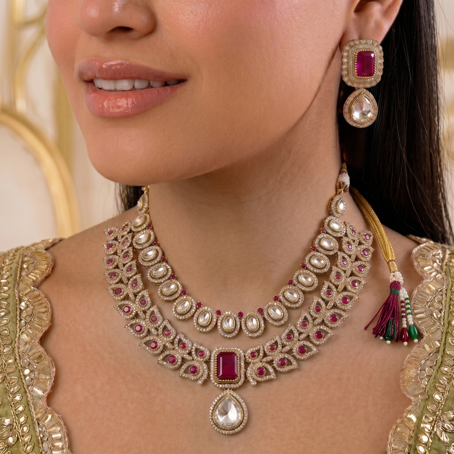 gold-plated layered jewellery set by Auraa Trends featuring red and white kundan stones