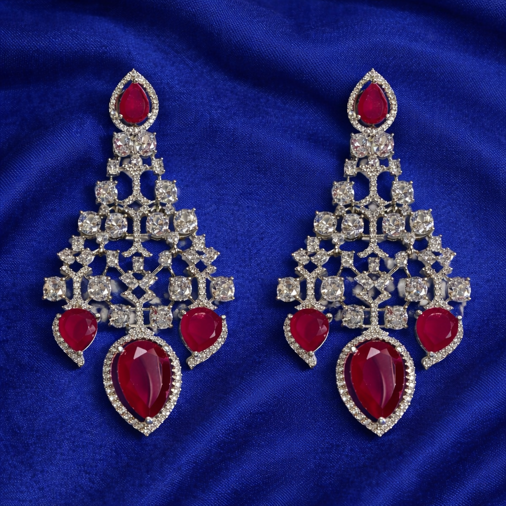 chandelier-style earrings featuring red stones and silver plating