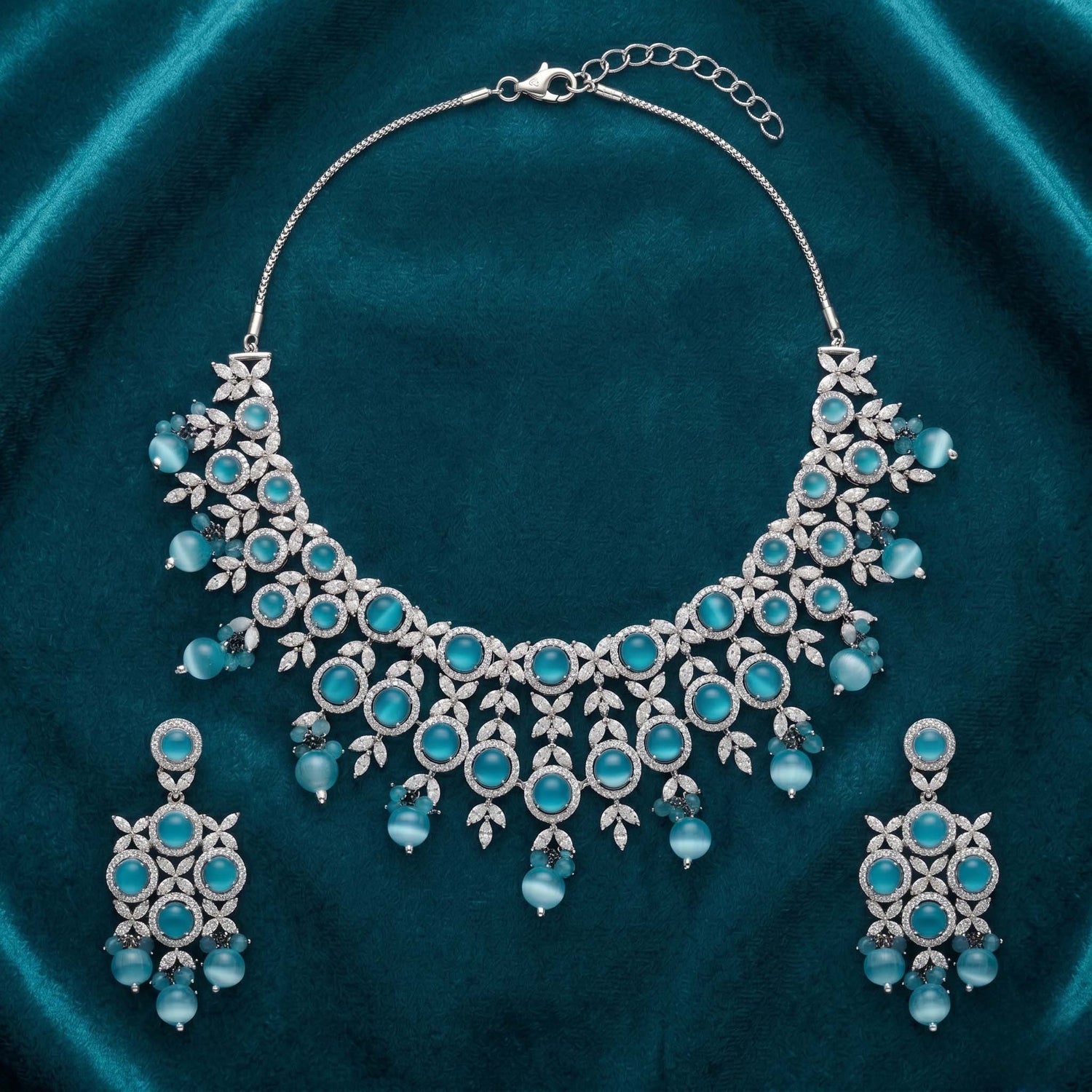silver-tone necklace and earring set featuring light blue stones and American Diamonds