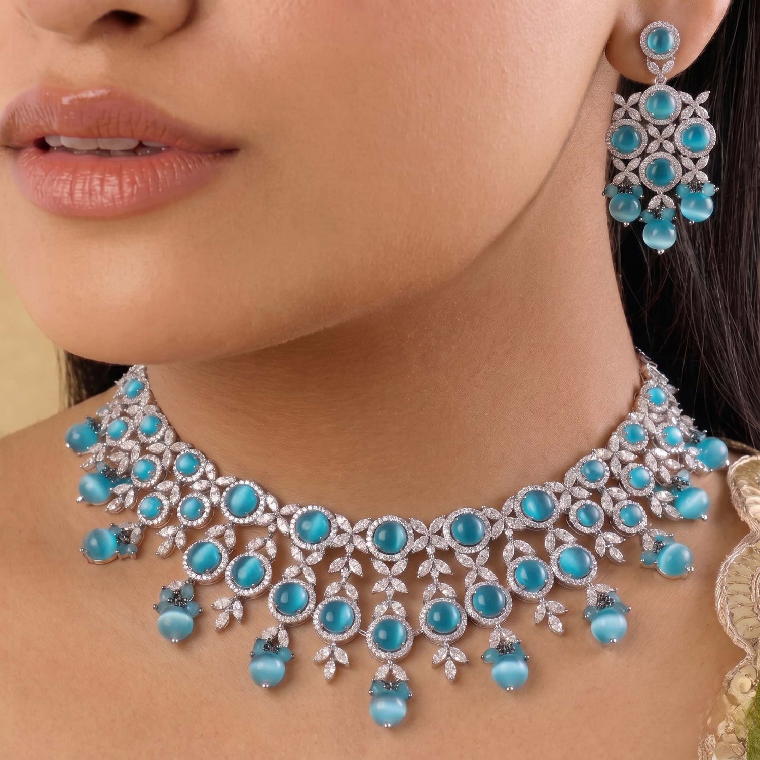 silver-tone necklace and earring set featuring light blue stones and American Diamonds